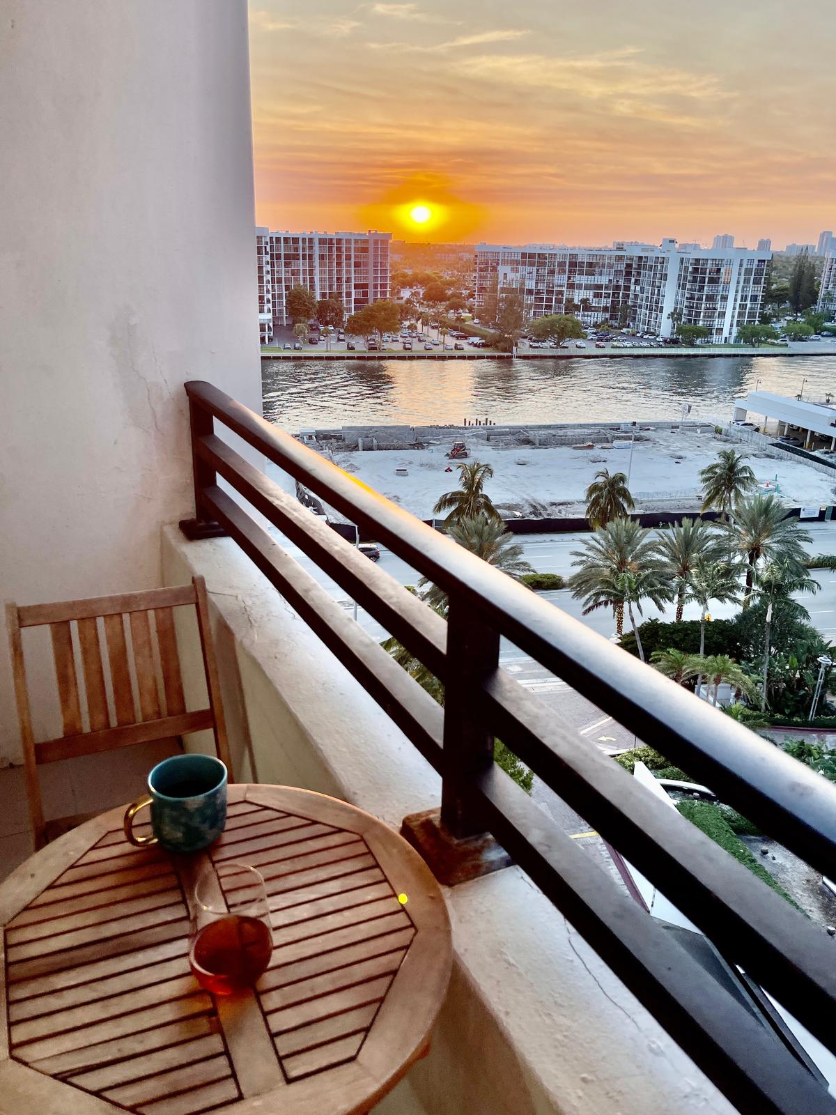 Teak bistro table and chair on the private balcony overlooking the Intracoastal at sunset